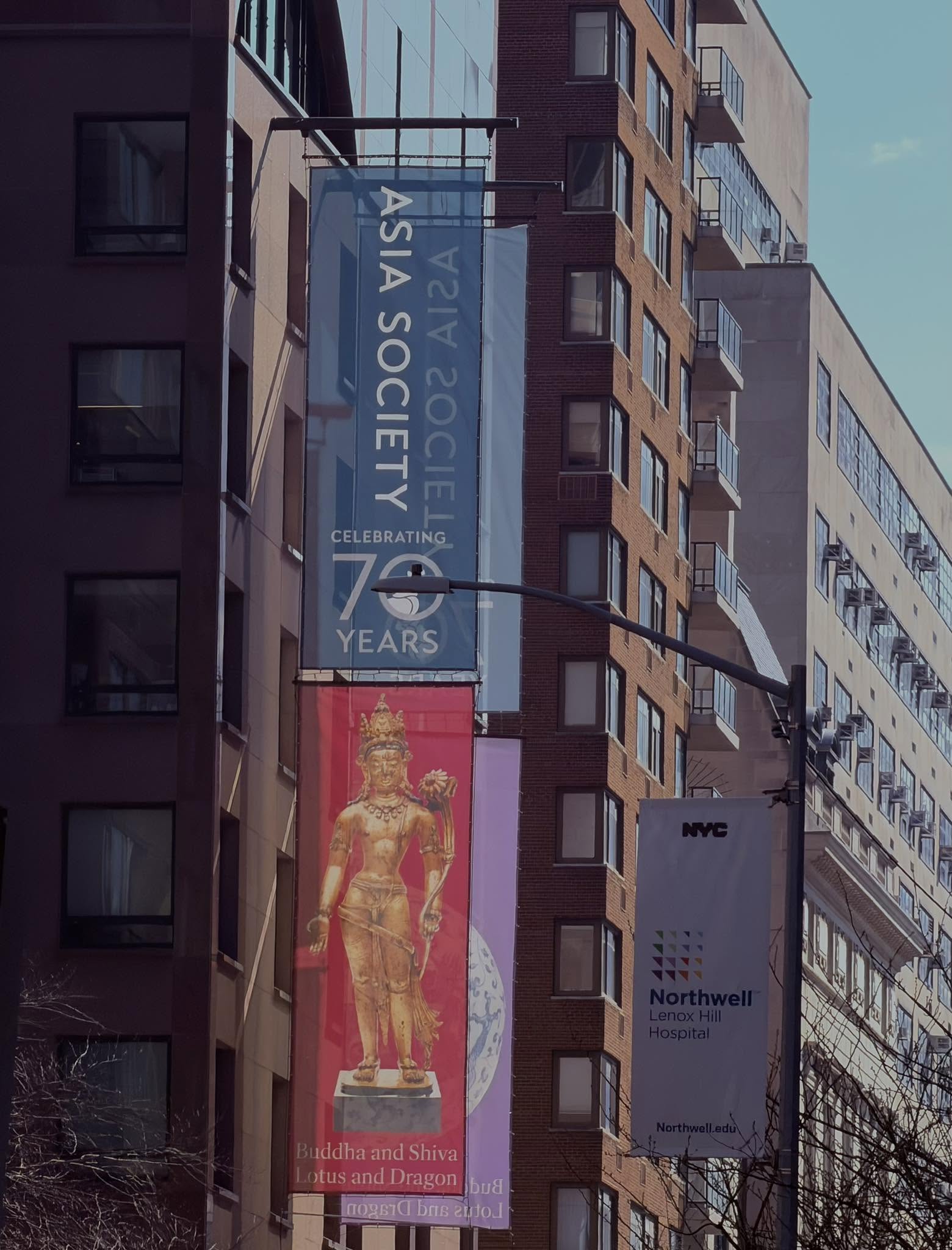 The Asia Society building on Park Avenue, its banners celebrating 70 years and the 'Buddha and Shiva, Lotus and Dragon' exhibition.