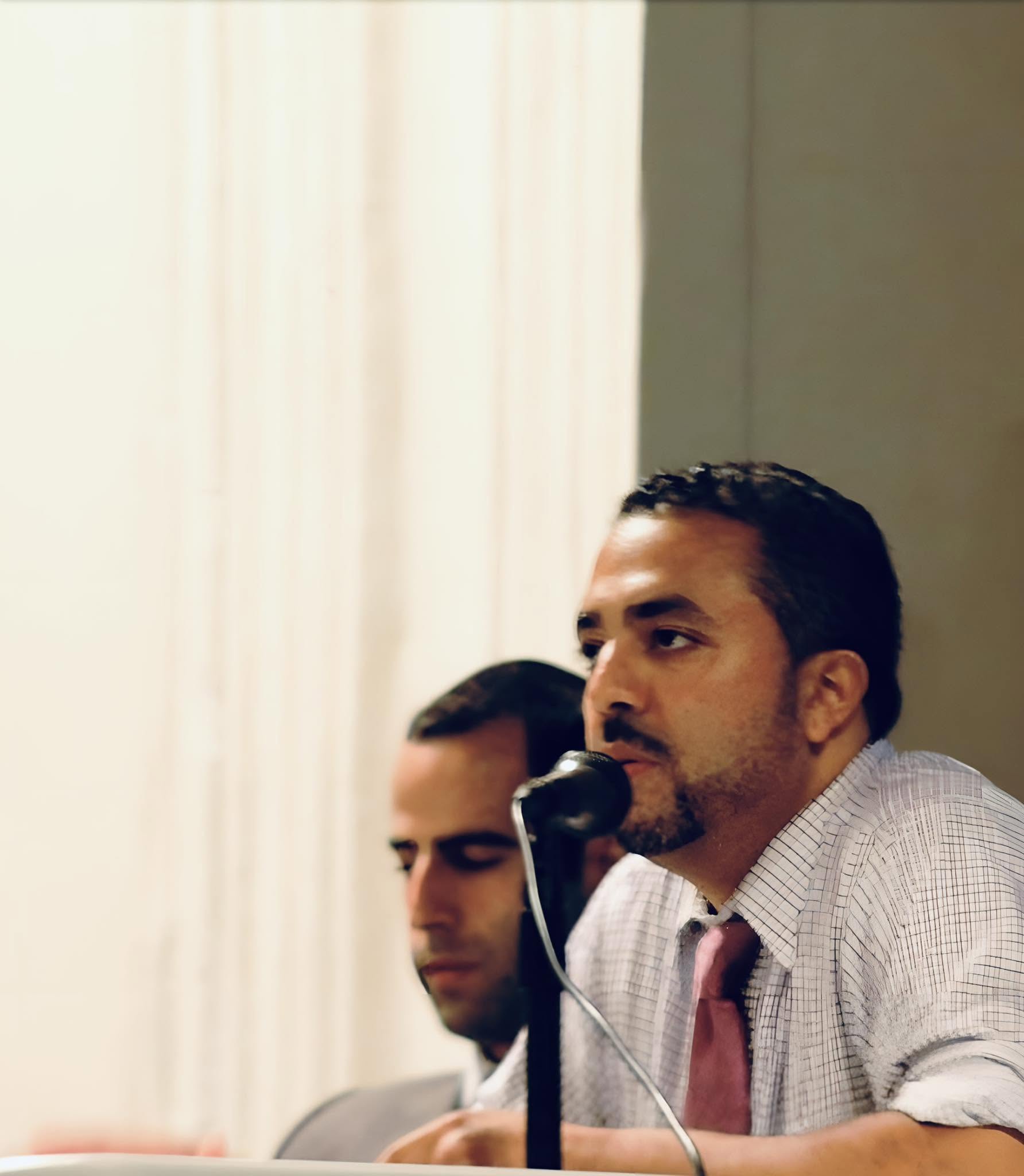 Peter M. Rivera speaks into a microphone.