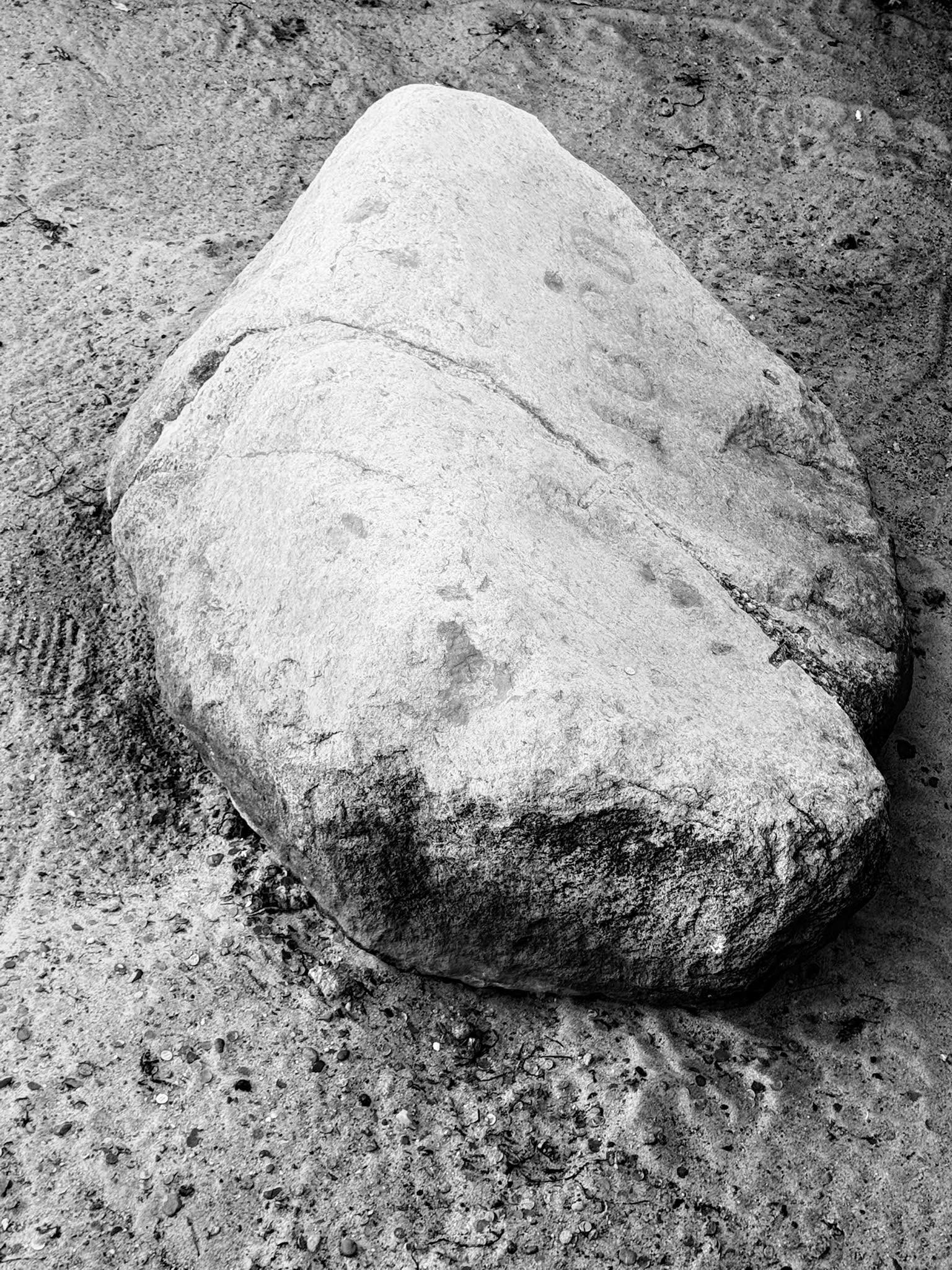 Plymouth Rock, the gray boulder resting in sand.