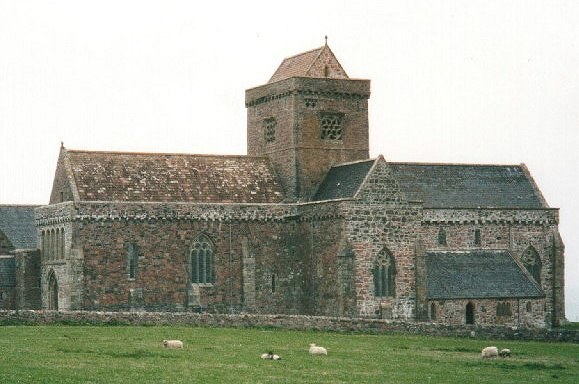 The abbey church with sheep grazing in the foreground field
