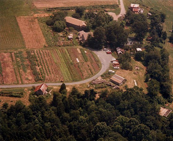 Aerial view of Twin Oaks' main entrance, communal gardens, and farm buildings