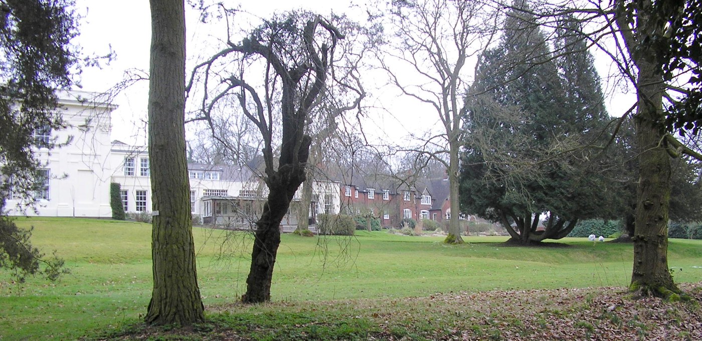 Grounds overview across the lawn to the campus buildings