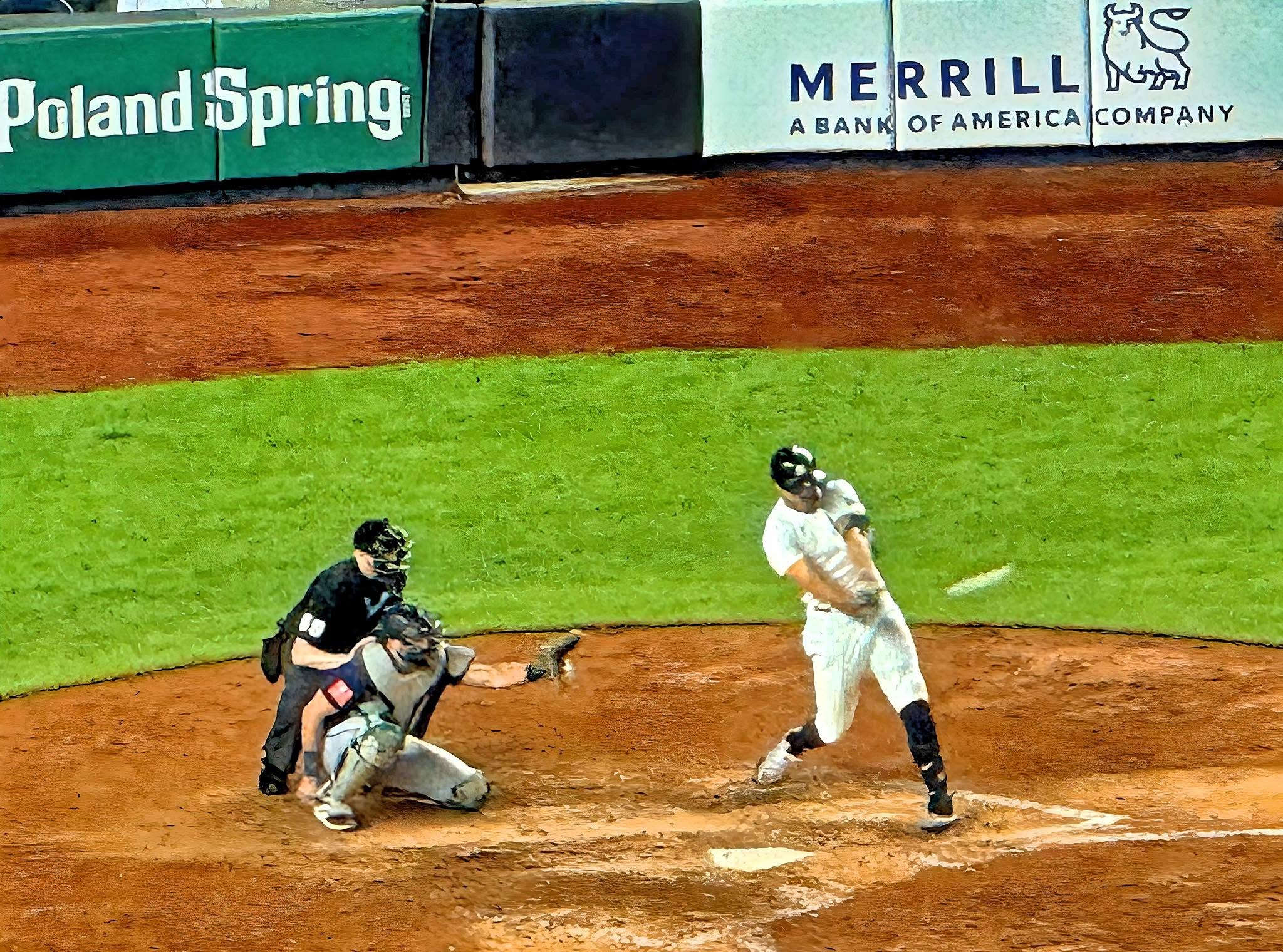 A Yankees batter swings at a pitch at home plate, with outfield-wall advertising behind him