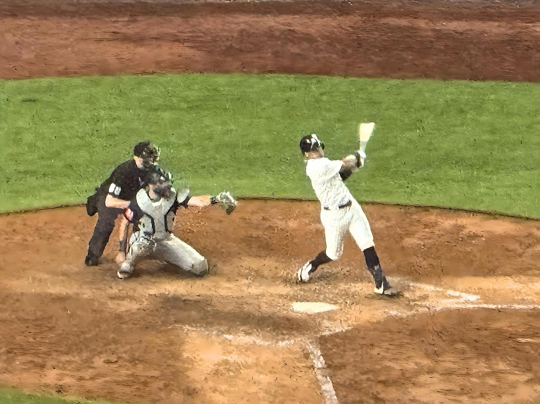 A Yankees batter finishes a high swing as the catcher reaches for the pitch