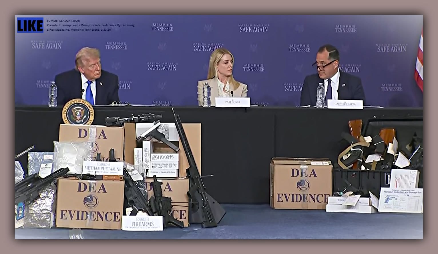 A video still of President Donald Trump, Attorney General Pam Bondi, and Kash Patel at a Memphis Safe Task Force press conference, seized firearms and narcotics evidence displayed before them.