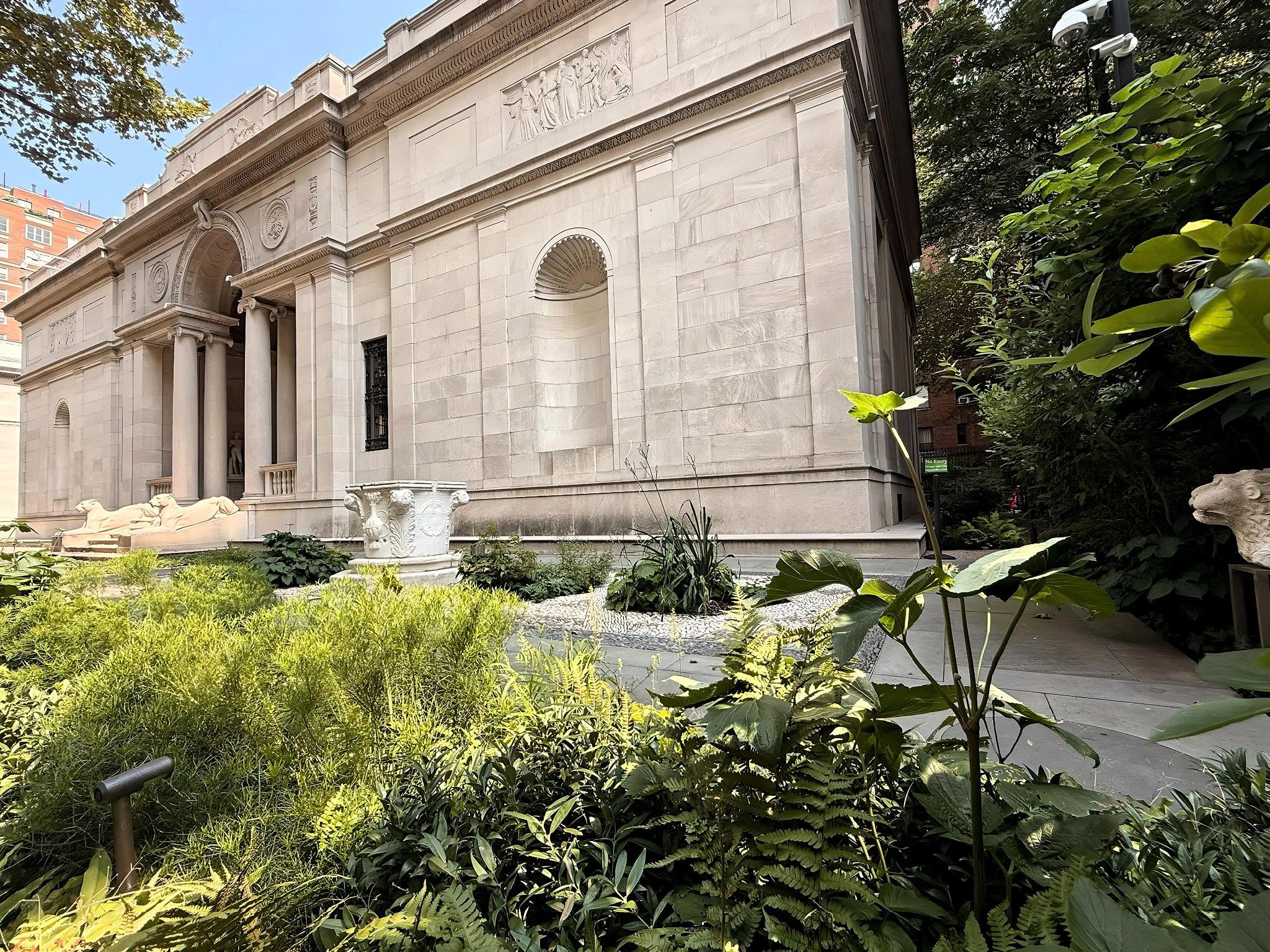 The Morgan Library and Museum's limestone facade rising above its garden court.