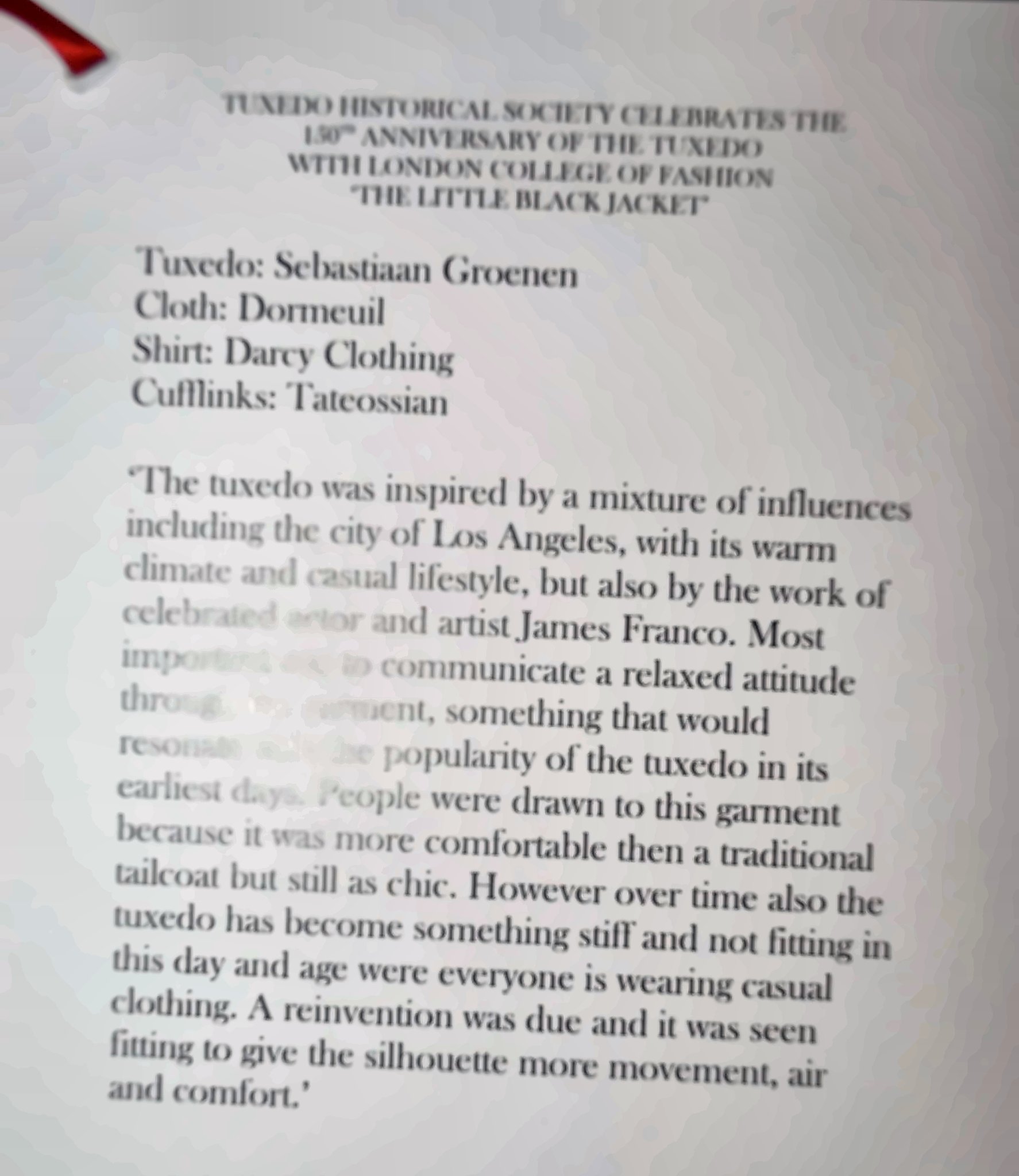 Exhibit card. Tuxedo: Sebastiaan Groenen. Cloth: Dormeuil. Shirt: Darcy Clothing. Cufflinks: Tateossian. (Lamp glare hides part of the text.)