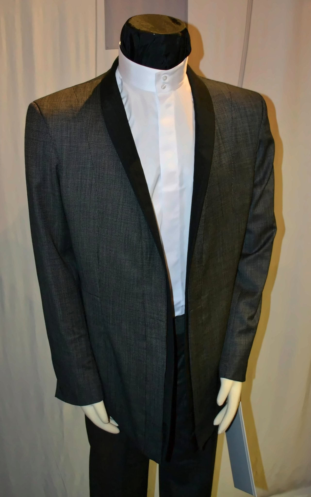 Sebastiaan Groenen's dinner jacket on a mannequin: a dark, textured cloth with broad black shawl lapels, worn over a white shirt.