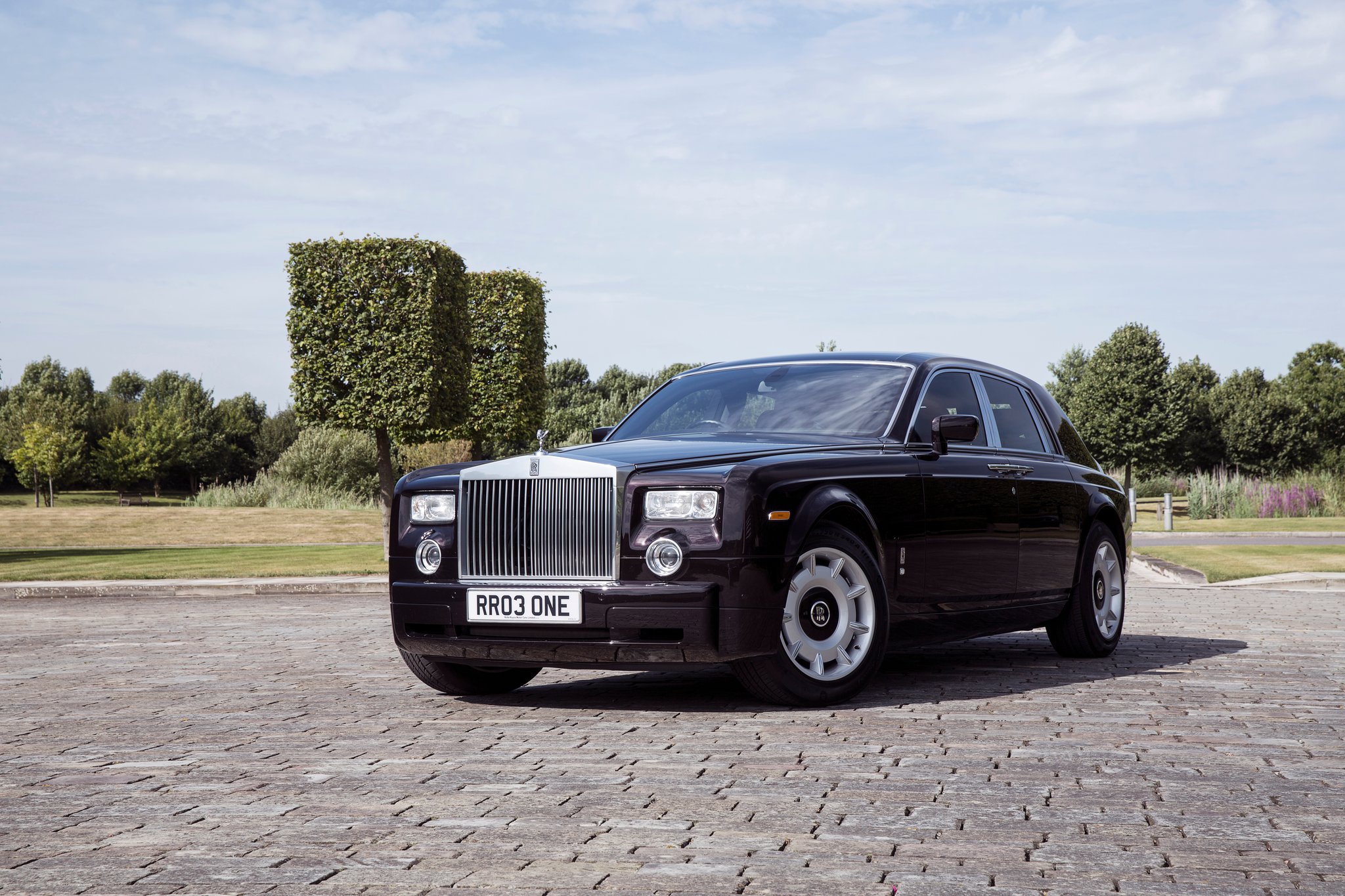 A black Goodwood-era Phantom, the modern heir to a century of black-tie arrivals.